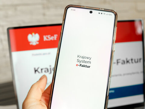 KSeF or Krajowy System e Faktur is Polish Mandatory B2B electronic invoicing system. Application on a mobile phone or smartphone and webpage on laptop screen, Wrocław, Poland - February 3, 2026