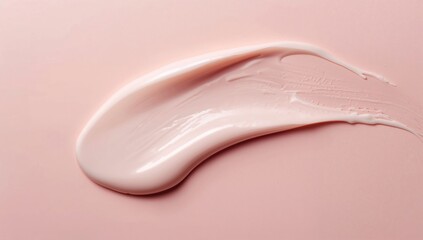 Fototapeta premium Swatch of Cream on Soft Pink Background Showing Texture and Shine in a Simple Layout