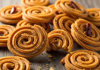 Fototapeta premium Delicious South Indian Murukku or Chakli snack, a crispy and crunchy fried flour spiral, presented in a close-up, appetizing food photography style.