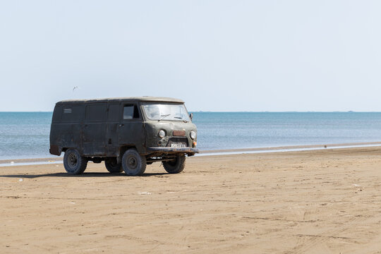 An old, used, mud-splattered UAZ-452 van