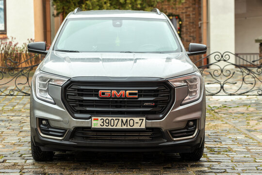 A modern silver gray GMT Terrain AT4 SUV car is parked