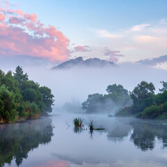 Misty lake reflects lush trees, pink clouds above a shrouded peak. Serene landscape