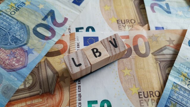 LBV acronym made of wooden letter cubes on pile of Euro banknotes. Lebensversicherung (Life Insurance)