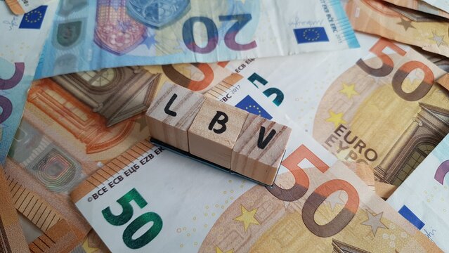 LBV acronym made of wooden letter cubes on pile of Euro banknotes. Lebensversicherung (Life Insurance)