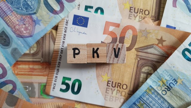 PKV acronym made of wooden letter cubes on pile of Euro banknotes. Private Krankenversicherung (Private Health Insurance)