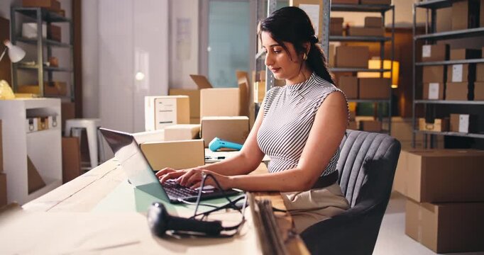 Small business, woman or laptop in warehouse for ecommerce, review website or answer order query. Online shopping, supply chain or entrepreneur typing with pc, supplier email or startup planning