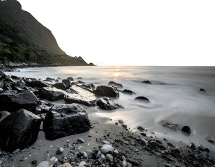Rugged rocky shoreline featuring dark coastal boulders.