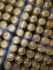 Golden aluminum beer cans in a supermarket