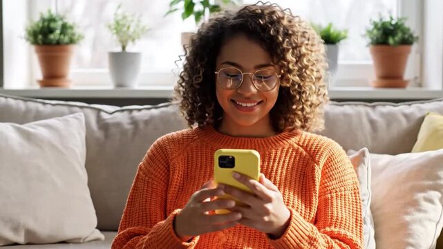 Digital Connection: A woman, immersed in the digital realm, gazes at her phone with focused concentration, the sunlight gently illuminating her and highlighting the comfortable living space.