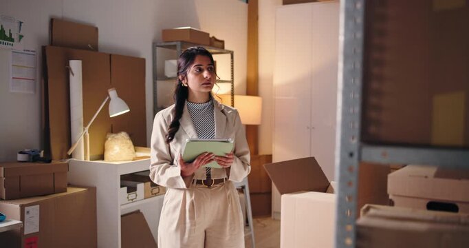Shipping, stock inspection and woman with tablet in office for logistics, warehouse and night. Tech, ecommerce or person in small business for inventory, storage or check boxes at shelf on late shift