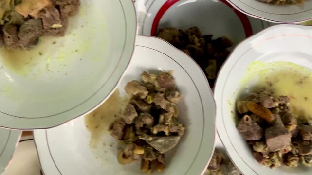Traditional Indonesian mutton curry or gulai kambing on white plates
