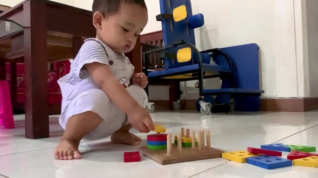 little Child playing with Montessori Wooden Geometric Shape Sorter