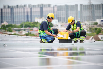 Engineers inspecting solar panels on a rooftop