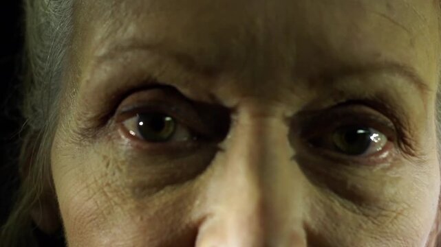 A closeup shot on the eyes of an old woman while she is talking to the camera, scene in a sci-fi movie