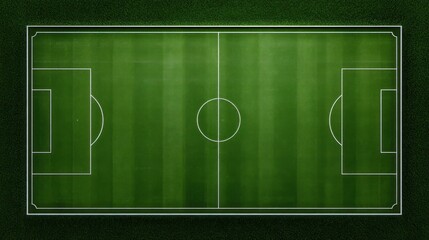 Aerial view of a soccer field with white markings on a green grassy surface surrounded by a dark environment