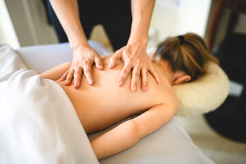 Professional masseur makes massage to a child girl