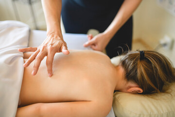 Professional masseur makes massage to a child girl