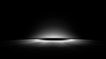 A spotlight shines down on an empty stage from above in a dark theater environment