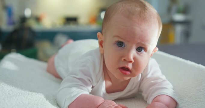 Slow Motion Of Curious Baby Rolling And Looking Toward Camera At 1000 FPS. Concept Of Discovery And Development