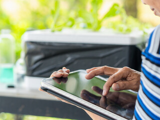 Close up people check vegetables hydroponic farm in garden by tablet AI technology at house for concept small business, start up, work from home. Sustainable environment authenticity. Plant care. © Яe Life Яe World