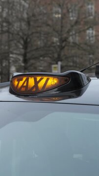 London black cab taxi sign lit up. Vertical Video