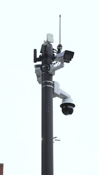 Outdoor cctv security cameras monitoring public area. Vertical Video