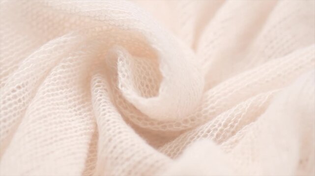 Soft Wool knitted background. Light pastel Alpaca wool mohair clothes texture closeup. Cashmere Soft and fluffy merino wool macro shot. Top view woolen fabric backdrop. Rotating, from above. 