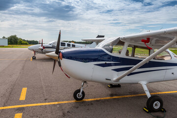 Small private airplanes parked at the airfield
