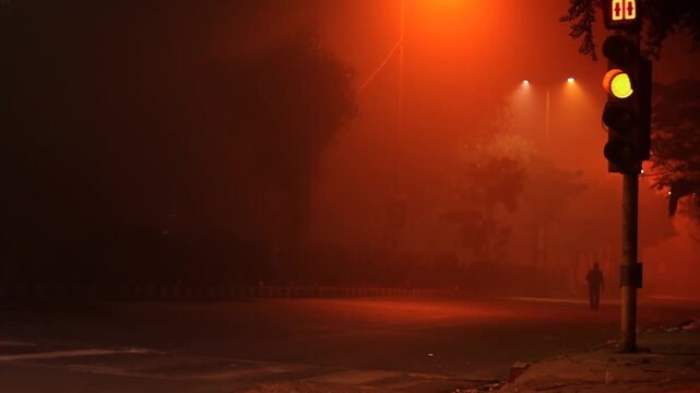 Traffic on highway in winter during foggy night.