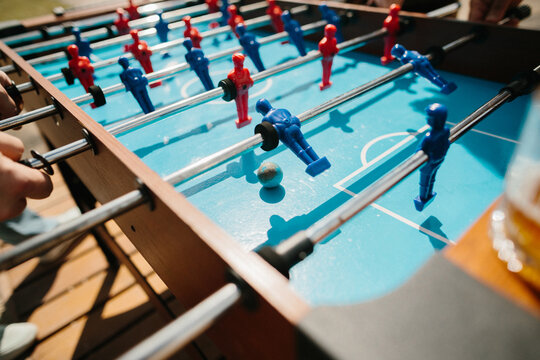 People playing foosball game on outdoor table