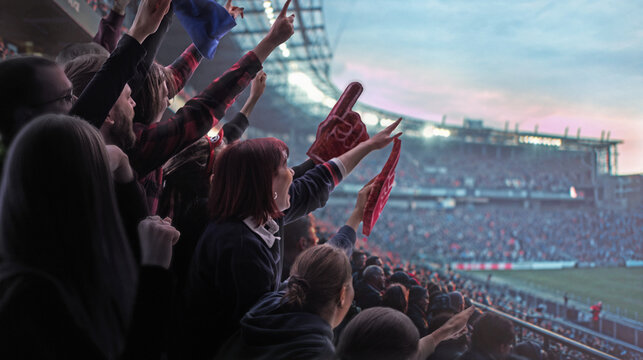 Crowd of supporters cheering from stands during soccer game composition. Concept of collective excitement, fan engagement, emotional connection, stadium energy, and live sports broadcasting content.