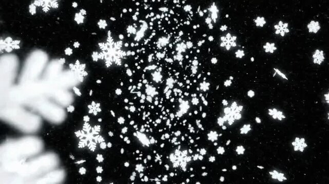 Snowflakes fall in a dark sky creating a winter scene with movement and patterns