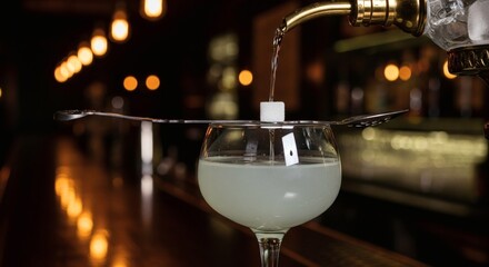 Absinthe Cocktail Preparation: Sugar Cube Drip Method in Bar, Cozy Ambiance, Golden Hour Lighting, Bartender Pouring Water perfect for National Absinthe Day