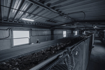Fototapeta premium Belt conveyor in underground tunnel of concentrating plant. Transportation of ore to surface factory