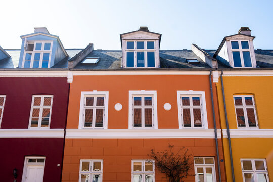 Quiet street moment showing architecture facade and colorful house windows roof gable in copenhagen denmark with spring light and clear sky