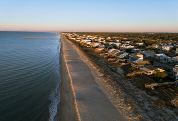 Aerial view of the pier and beach homes at sunrise in Oak Island , in Brunswick County, North Carolina