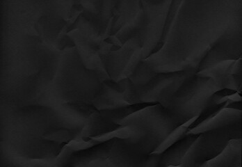 High-resolution black crumpled paper texture with deep folds and subtle shadows, full frame background.