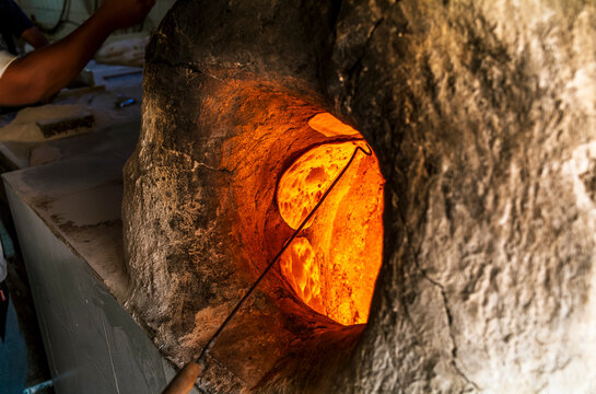 Traditional bahraini flatbread baking in a traditional clay oven in Muharraq