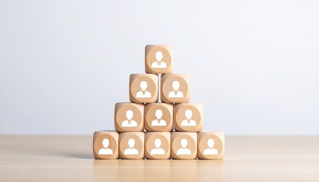 Pyramid of Wooden Blocks with Business Figure Icons Representing Corporate Hierarchy and Management Structure