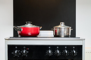 Two saucepans placed on an electric stove