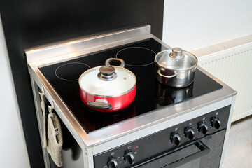 Two saucepans placed on an electric stove