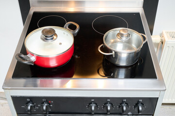 Two saucepans placed on an electric stove
