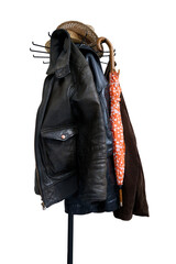 coat rack with an orange umbrella and a few wicker hats