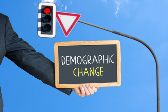 demographic change, traffic light with a warning triangle in the background