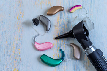 Hearing Aids and Otoscope on a Wooden Table