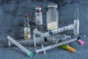 Collection of Medical Tools and Vials on a Table