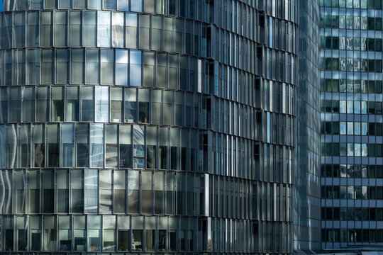 Modern corporate office skyscraper architecture shows glass facade reflection in Paris La Defense with abstract window pattern and texture