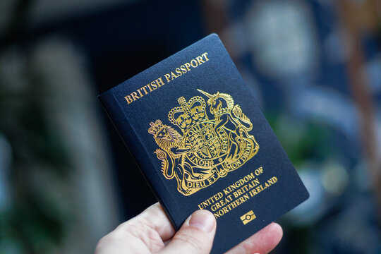 British passport held in hand in a modern lifestyle setting, representing travel, identity, and international mobility