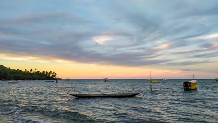 Naklejka premium Blue waters surround Moreré Beach on Boipeba Island, Bahia, where sunrise and sunset create unforgettable scenes.