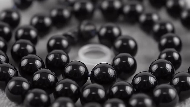 glossy black bead necklace close-up macro shot